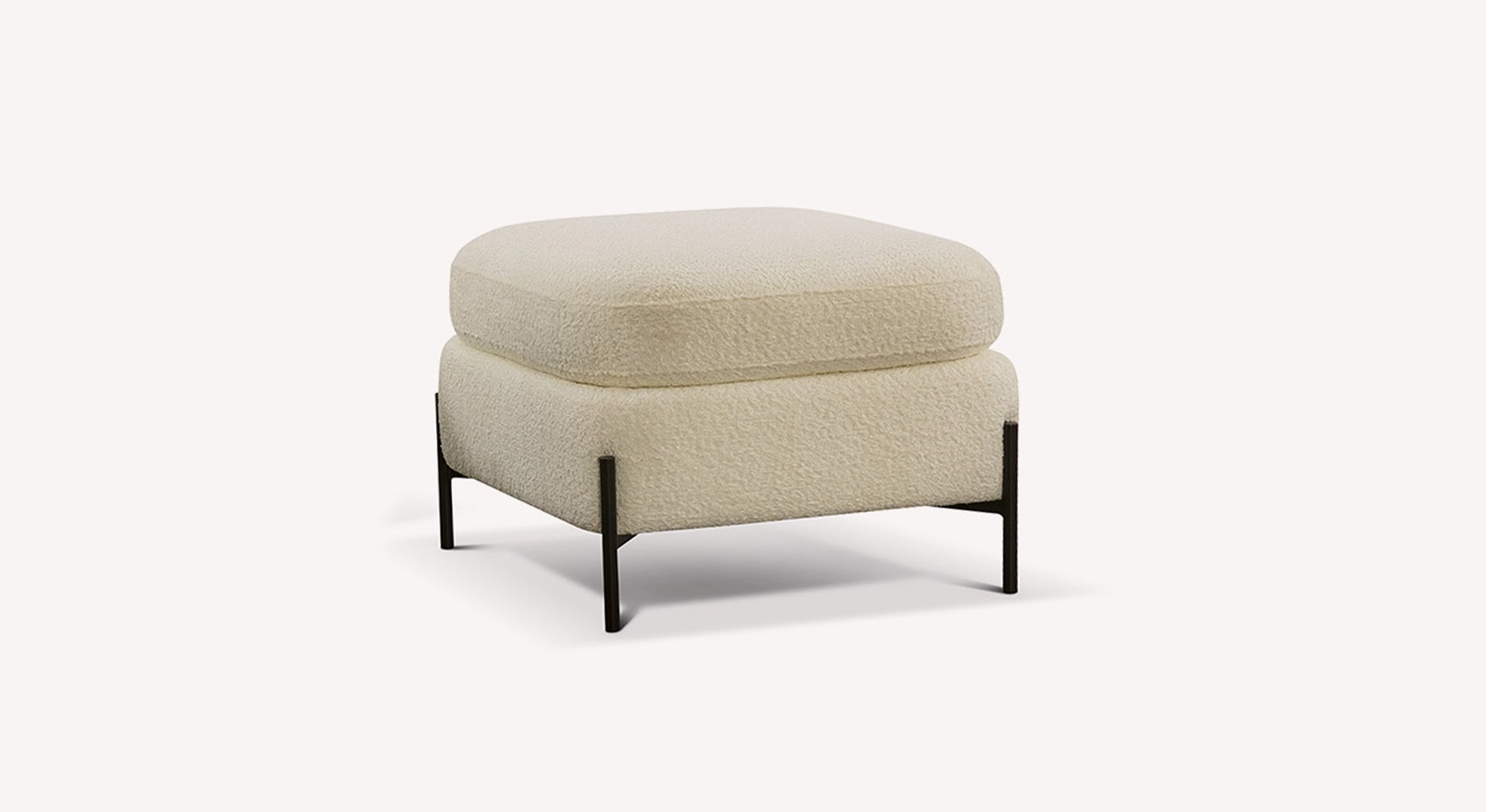 Pouf en tissu ivoire avec pieds noirs, design moderne et minimaliste