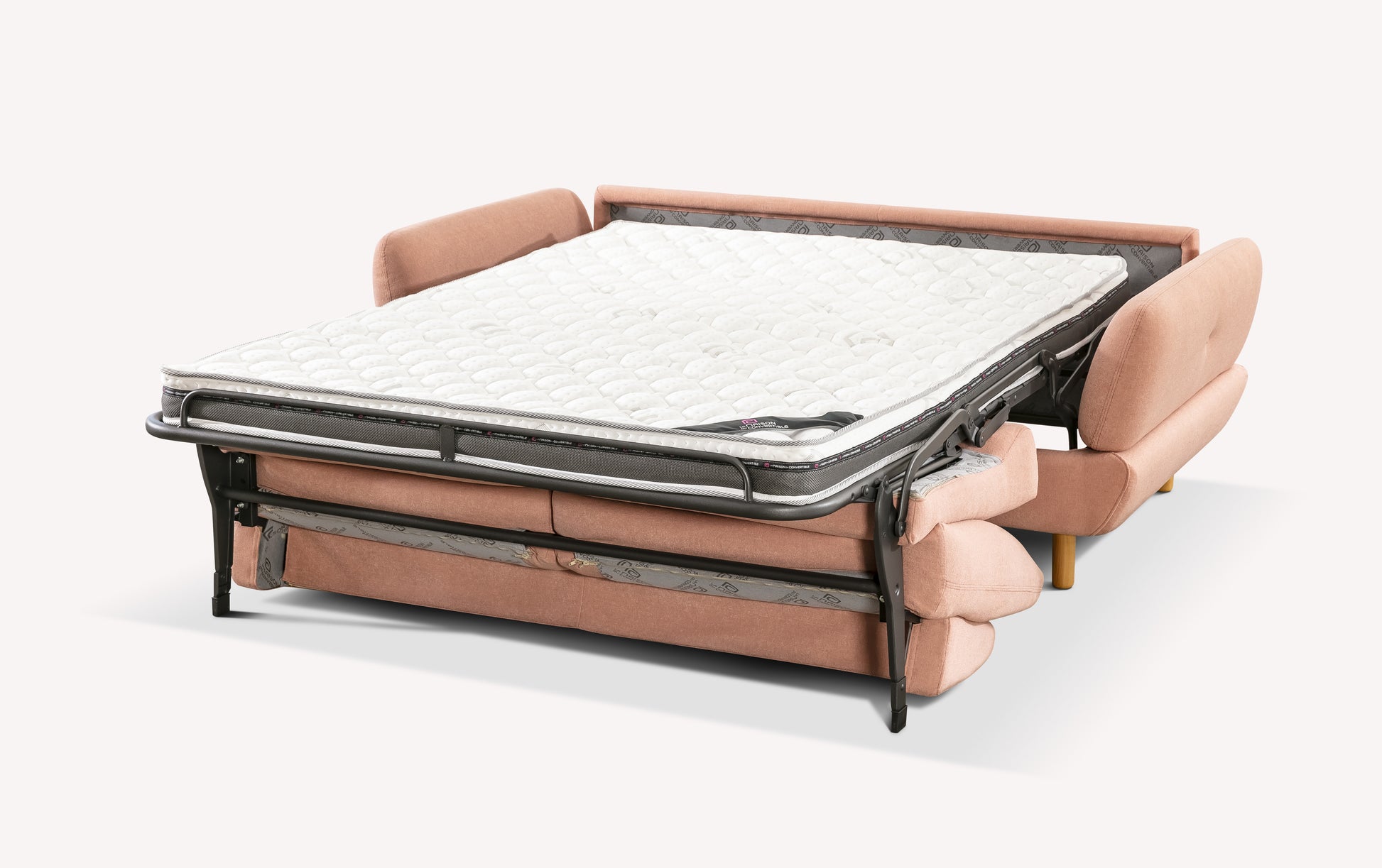 Canapé convertible en tissu rose "flamingo" avec matelas déplié, style moderne et pieds en bois