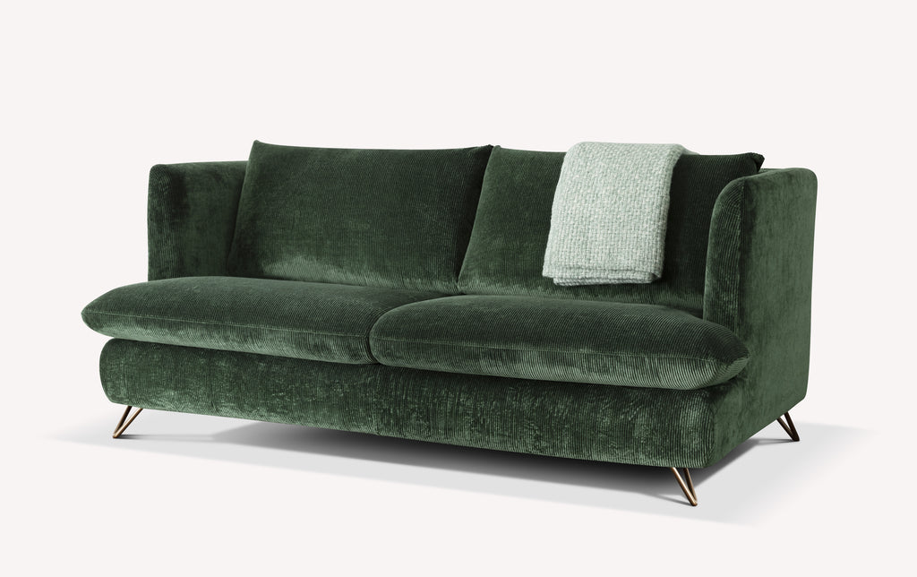 Canapé convertible en velours côtelé vert bouteille avec pieds métalliques et plaid gris clair sur l'accoudoir